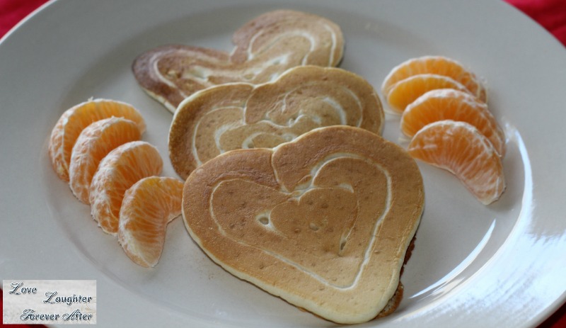 Valentine's Day Treats Ideas heart shaped pancakes served with orange slices